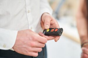 A close up of a person holding a mini guide.